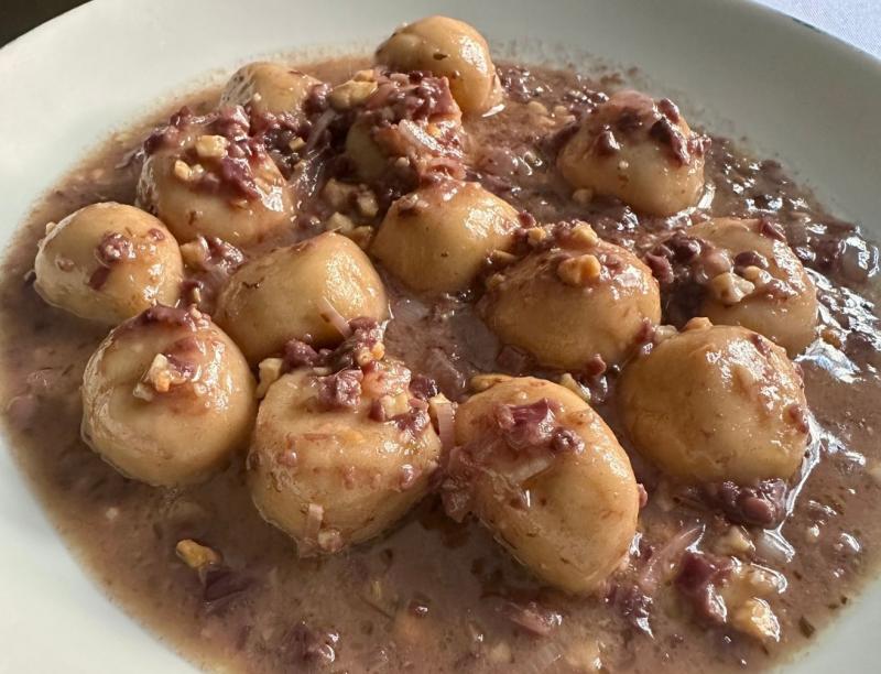 Gnocchi Delle Radici (Nhoque de Tubérculos): uma base de nhoque de tubérculos, servido com manteiga derretida, azeitona preta, aliche e castanha de caju